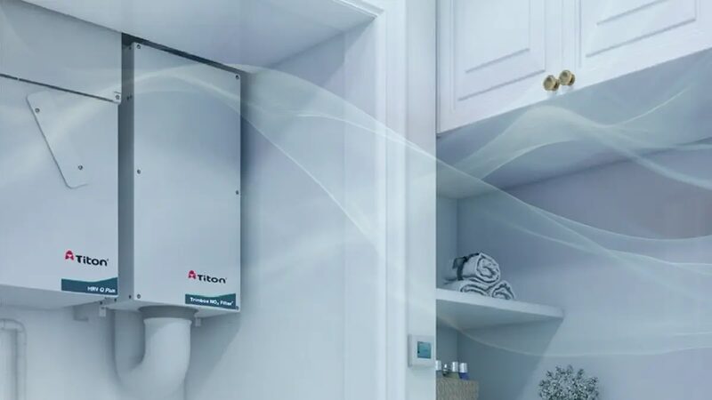 Titon HRV Q Plus mechanical ventilation heat recovery units mounted in a white utility cupboard with airflow visualisation