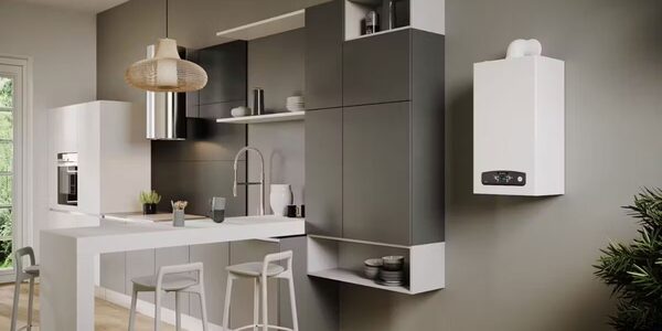 A white wall-mounted Ariston combi boiler installed on the wall of a modern grey and white kitchen