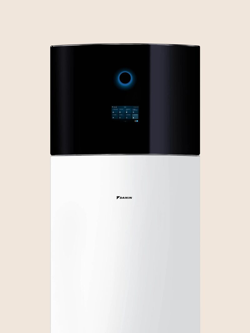 A Daikin air-to-water heat pump indoor unit, a tall white cylinder with a black control panel top