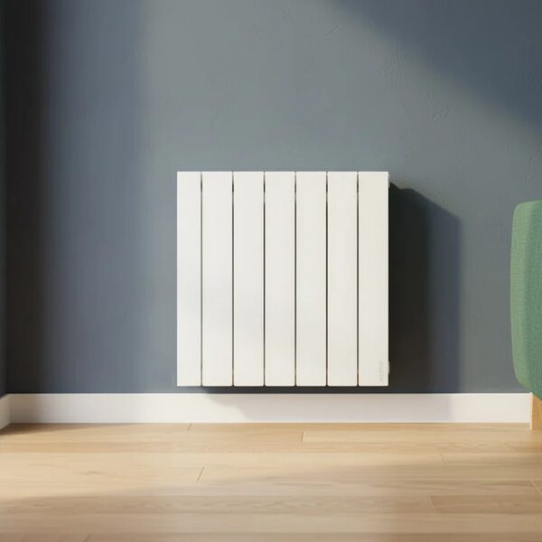 A white Atlantic Accessio electric thermofluid radiator mounted on a grey wall above a wooden floor