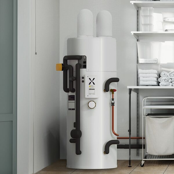 A white Mixergy hot water cylinder with black pipework installed in a utility room