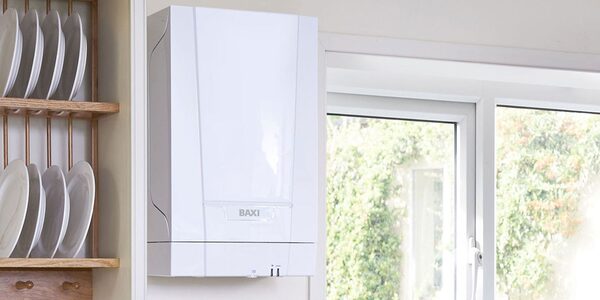 A white Baxi wall-mounted combi boiler installed in a kitchen next to a window and plate rack