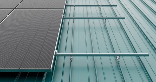 Solar panels mounted on a standing seam metal roof using aluminium mounting rails and clamps
