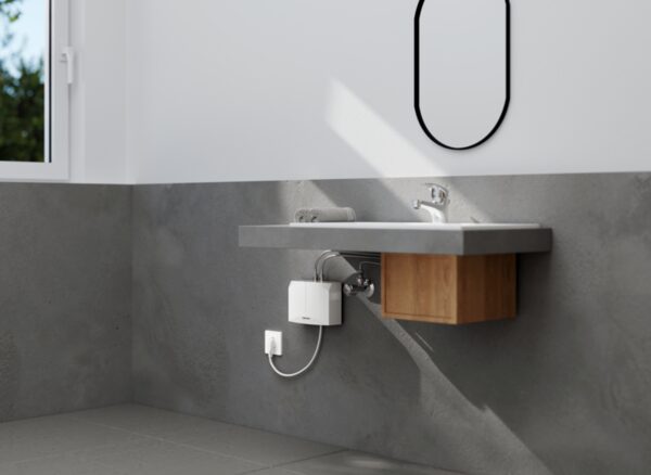 A Stiebel Eltron mini instantaneous water heater installed under a bathroom sink