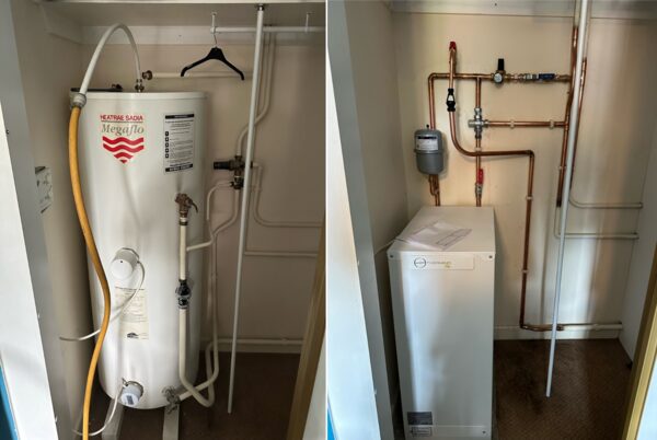 A side-by-side comparison of an old Heatrae Sadia Megaflo hot water cylinder and a new Sunamp Thermino heat battery installed in an airing cupboard