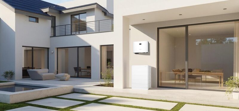 A Sungrow home battery and inverter unit mounted on the wall of a modern white villa's patio