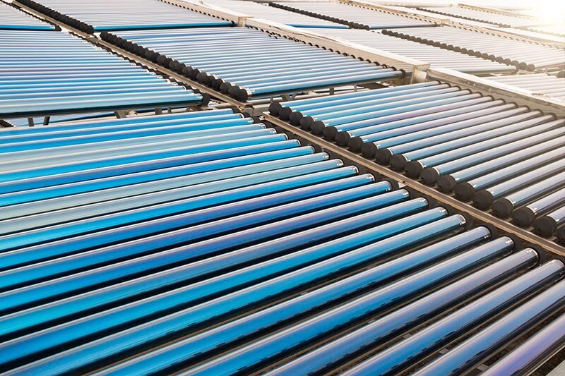 Rows of evacuated-tube solar thermal collectors installed on a roof