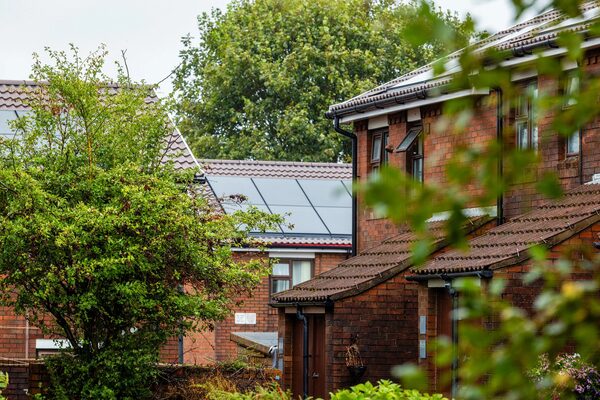 Brick houses with integrated solar panels on the roof at a housing estate in Wales