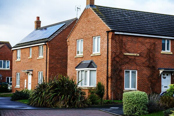 Brick UK houses with solar panels on one roof