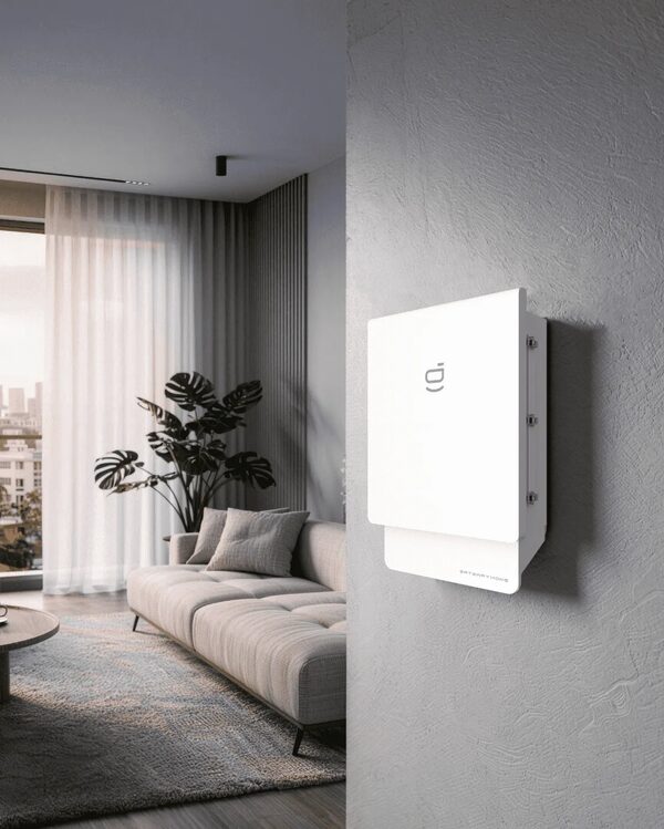 A white Sigenergy home battery unit mounted on a wall in a modern living room