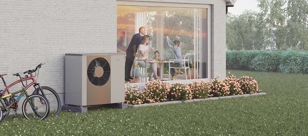 A NIBE air source heat pump unit installed outside a house next to a garden with bicycles and a family visible through the window