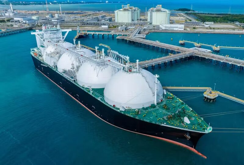 Aerial view of the Grain LNG terminal with large white LNG storage tanks on the Isle of Grain