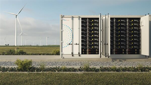 TrinaGrid containerised grid-scale battery energy storage units in a field with wind turbines behind