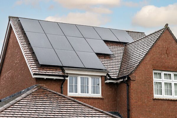 Solar PV panels installed on the tiled roof of a brick house
