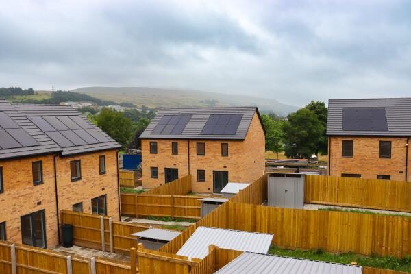 New brick houses with rooftop solar panels at a housing development in Ebbw Vale, Wales