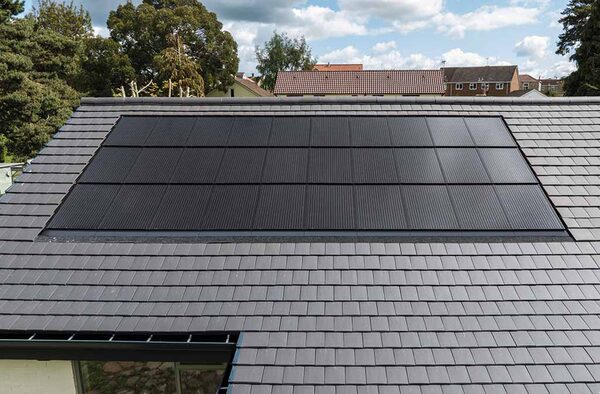 In-roof solar panels flush-mounted in a grey slate roof of a UK house