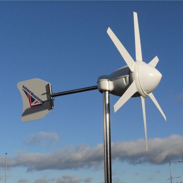 A Rutland Windcharger small wind turbine mounted on a pole against a blue sky