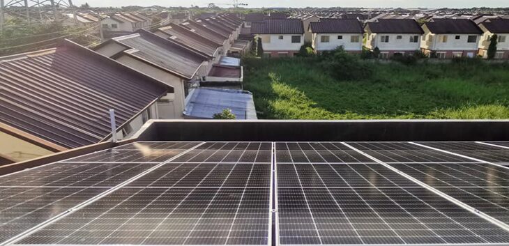 Rooftop solar panels overlooking a housing estate of terraced houses