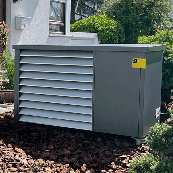 An iDM outdoor heat pump unit installed in a garden beside a house