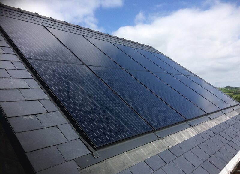 Roof-integrated solar PV panels installed flush on a slate-tiled pitched roof