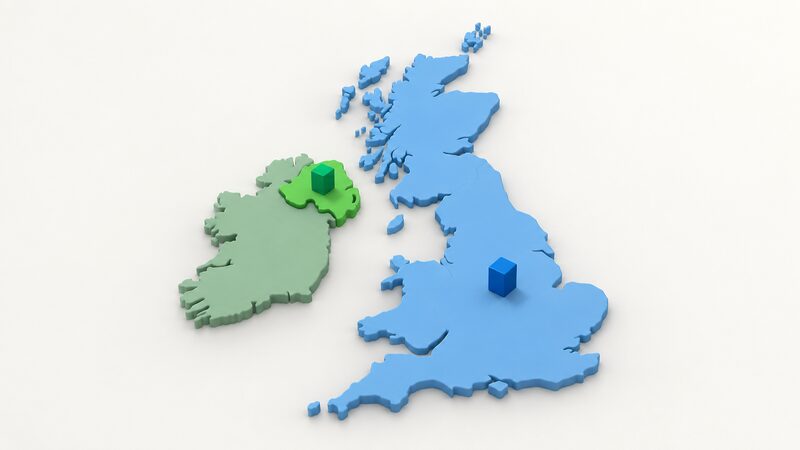 A simplified map of the British Isles with Northern Ireland shaded as one plain colour region and Great Britain as another, each carrying a plain marker block standing for its regulator, the Utility Regulator in Northern Ireland and Ofgem across England, Scotland and Wales.