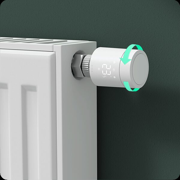 A white Aqara smart radiator thermostat dial fitted to a radiator valve, with a graphic arrow showing it twists to control the temperature
