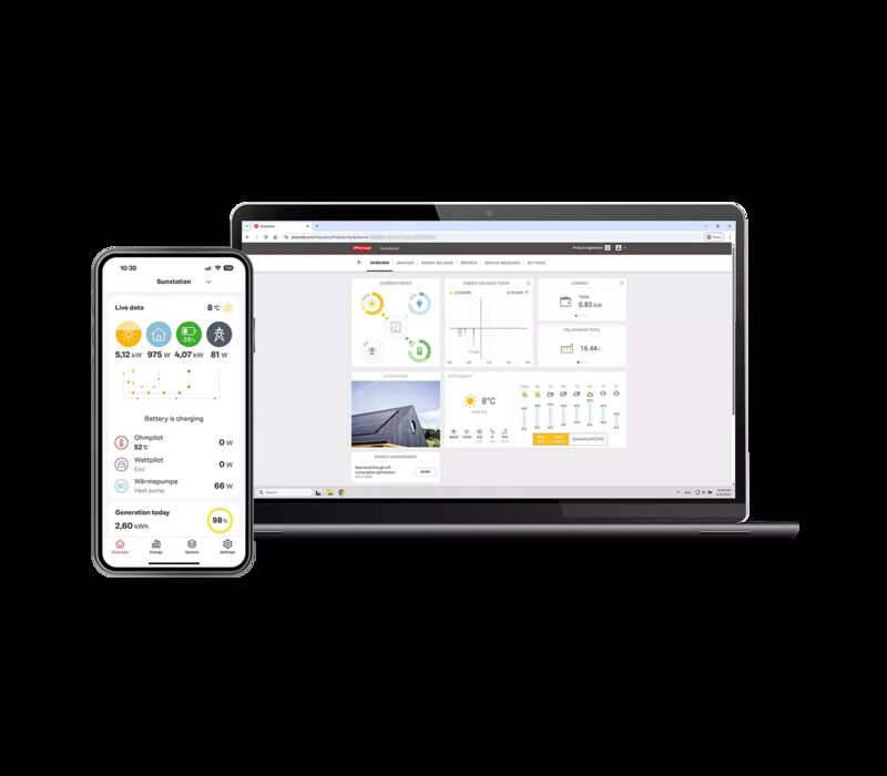 A laptop and smartphone displaying the Fronius Solar.web solar monitoring app with live energy data