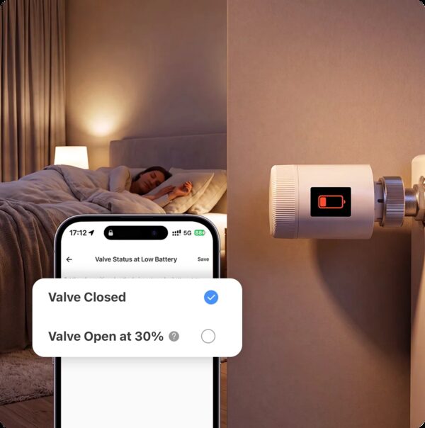 A SONOFF Zigbee thermostatic radiator valve on a radiator beside a bedroom, with a phone app showing low-battery valve status options