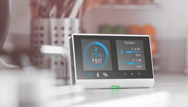 A smart energy monitor display on a kitchen worktop showing cost per hour and budget figures