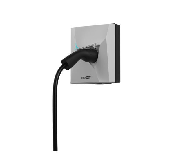 A white SolarEdge wall-mounted EV charger with a black charging cable and holster on a plain background