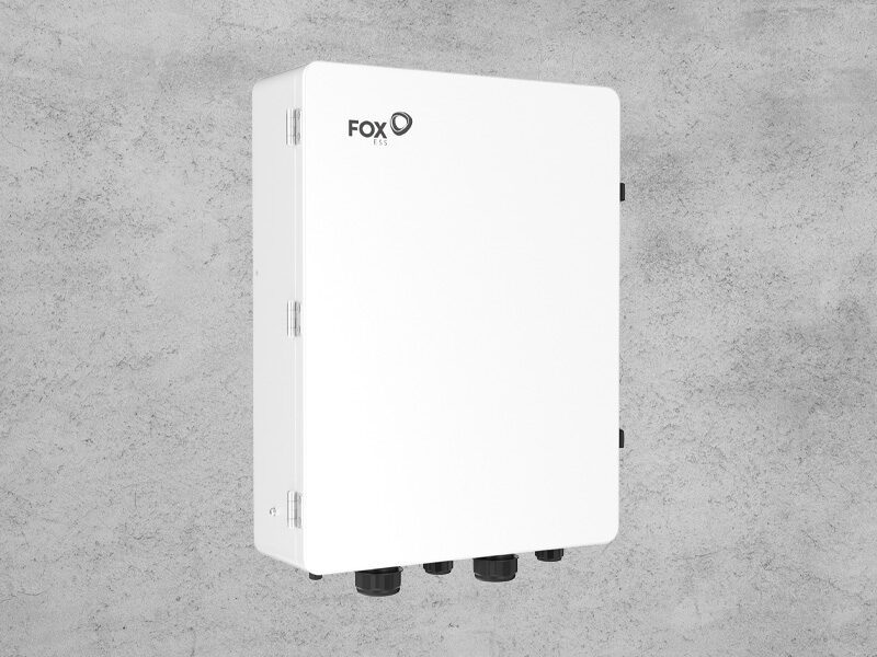 A white Fox ESS EPS-BOX-SP whole home backup gateway enclosure mounted on a grey concrete wall