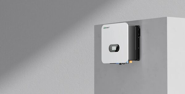 A white LuxpowerTek hybrid inverter mounted on a grey wall
