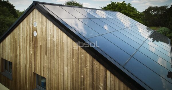 A timber-clad house with a large in-roof solar panel array covering the roof slope