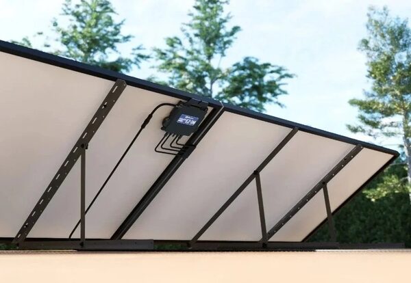 Underside of solar panels on a mounting frame with an AP Systems microinverter attached