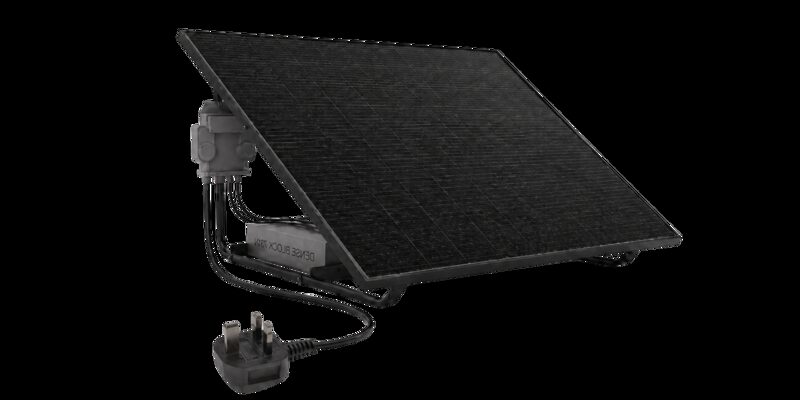 A plug-in solar kit with a black solar panel on a metal stand, inverter box and UK three-pin plug