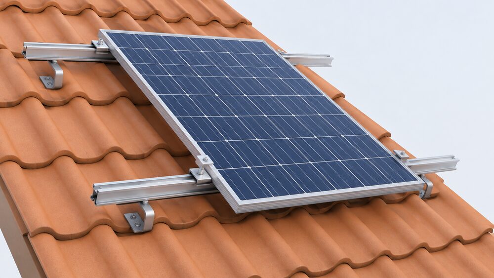 A close-up of an on-roof solar mounting system on a pitched roof: aluminium rails running over the tiles, fixed by roof hooks screwed into the roof structure, with a photovoltaic panel clamped to the rails, and no other equipment.