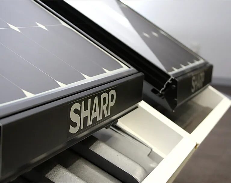 Two Sharp solar panels mounted in a roof-integrated display frame