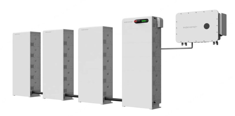 A Sigenergy SigenStor home battery system with three stacked battery modules, an inverter unit and a wall-mounted energy manager connected together