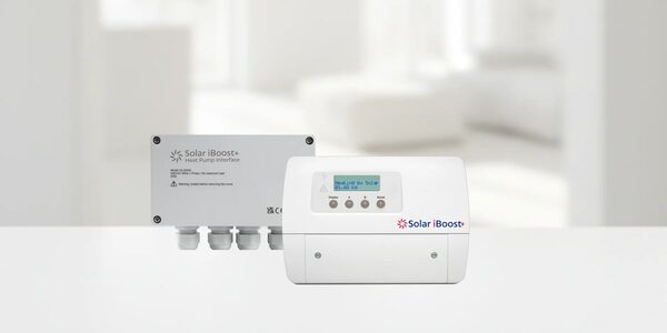Solar iBoost+ heat pump interface control units shown against a blurred white interior background