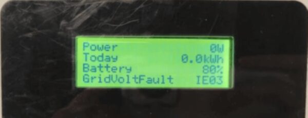 Close-up of a SolaX inverter LCD screen displaying power, battery percentage and a GridVoltFault IE03 error message