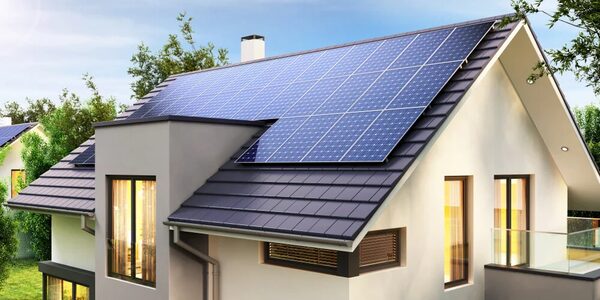 A modern house with solar panels installed on its tiled roof