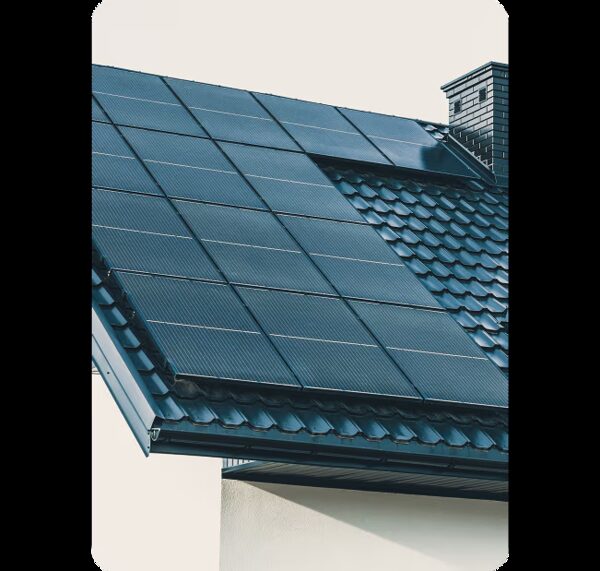 Solar panels fitted flush into the tiled roof of a house next to a chimney