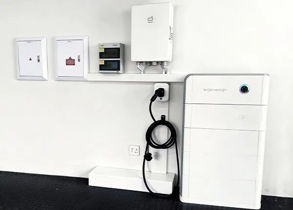 A Sigenergy home battery stack installed on a wall next to an EV charger, consumer units and distribution boards
