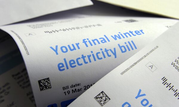 A close-up of printed paper electricity bills headed 'Your final winter electricity bill' with a bill date of 19 March