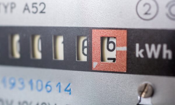 Close-up of a mechanical electricity meter dial reading in kWh