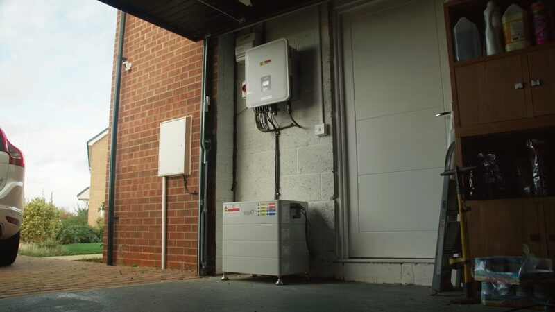 A Fox home battery and wall-mounted inverter installed in a garage
