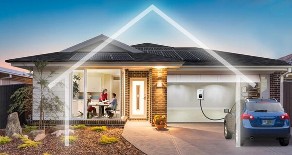 A house with rooftop solar panels and an EV charger in the garage charging a blue car, with a glowing house outline graphic